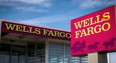 Wells Fargo blames low-interest rates and litigation charges for an over 50% drop in quarterly profit
